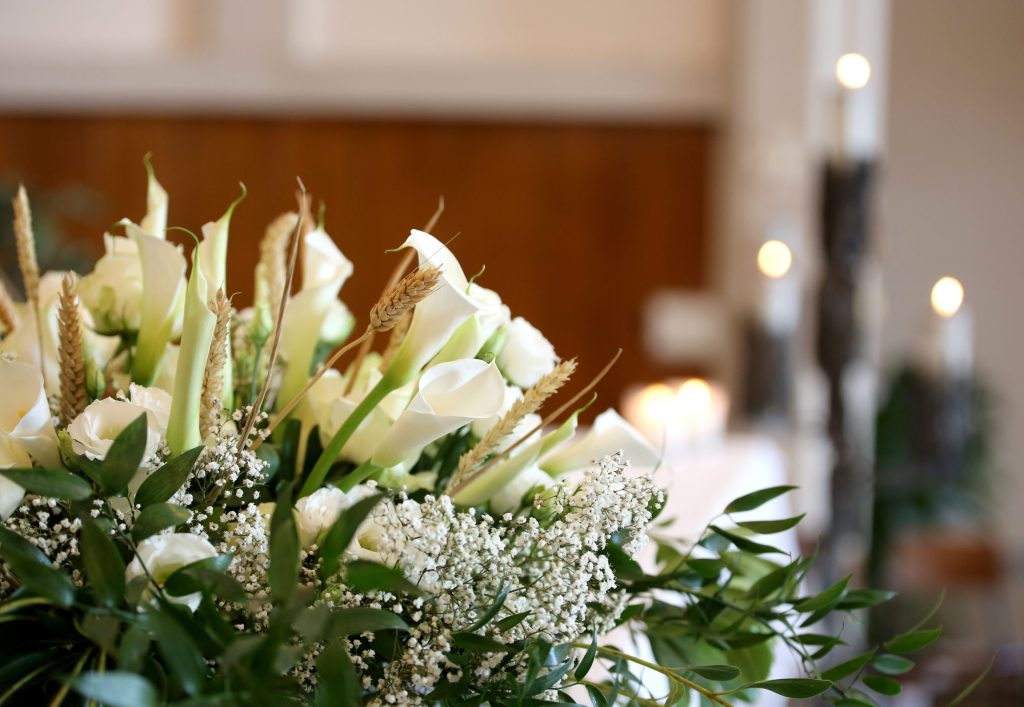 Flowers on an altar in the church and the candles on background